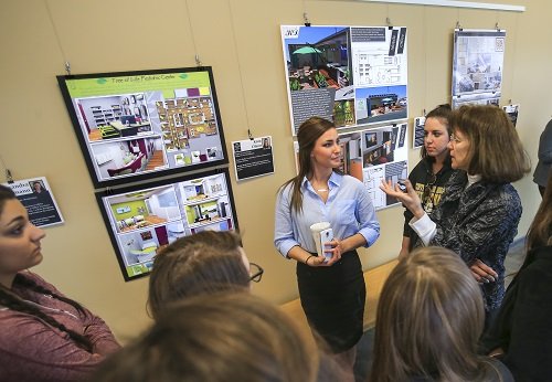 Picture of Jeanneane Wood-Nartker with student and her poster