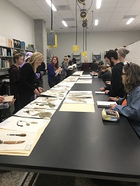 Anna Monfils with students in a lab reviewing plant samples