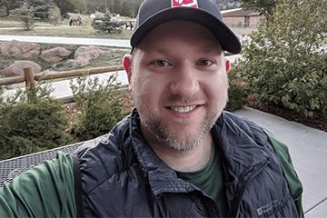 Robert Dvorak posing outside after receiving an award from the National Park Service, Sleeping Bear Dunes National Lakeshore, and Michigan State University.