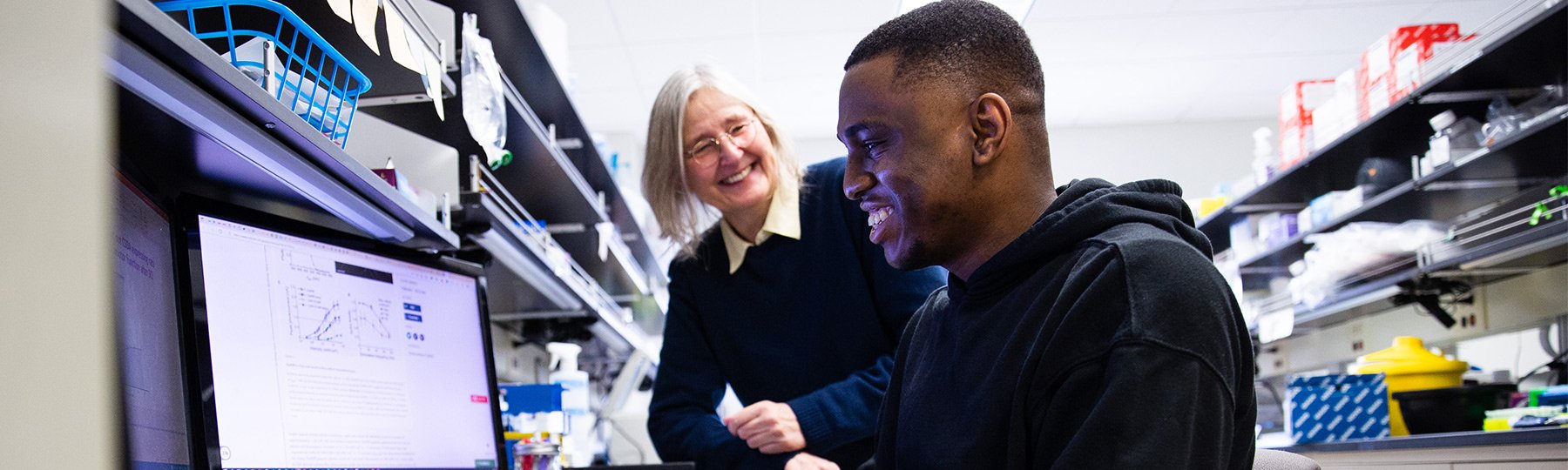 Faculty member and student from the College of Medicine conducting research on a computer.