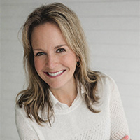 Deborah Gray smiling in a professional headshot, wearing a light sweater against a neutral background.