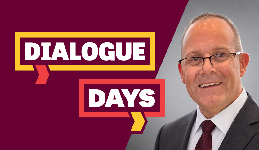 Kevin Goddard wears a gray jacket, white shirt and maroon tie in a Dialogue Days image.