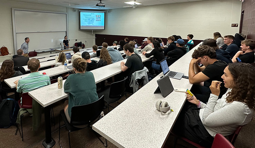 Students listen to an Alro Steel guest speaker during an Alpha Iota Delta Speaker Series event.