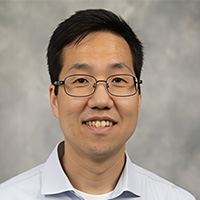 Jaeyoon Yu smiling in a professional headshot, wearing glasses and a light dress shirt against a neutral background.