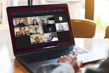 A laptop displaying a Microsoft Teams meeting with Central Michigan University College of Business Administration students, alumni and staff during the Alumni Connect pilot program.  Photo description (223 characters)
