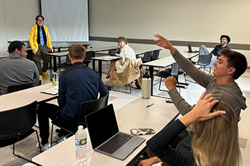 Students participate in an improv exercise during Jeff Hoyle’s MKT 420 Advanced Selling and Negotiation class as theatre faculty member Jody Price looks on.