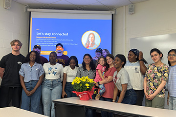 CMU Project Management chapter members pose with guest speaker Megan McBride Davis and other attendees in a classroom following a presentation by the Dow alumna.