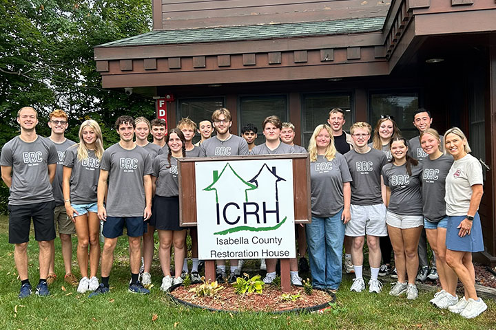 BRC students pose in front of the Isabella County Restoration House building during a community service visit.