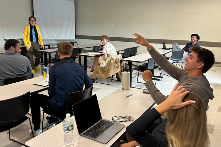 Students participate in an improv exercise during Jeff Hoyle’s MKT 420 Advanced Selling and Negotiation class as theatre faculty member Jody Price looks on.