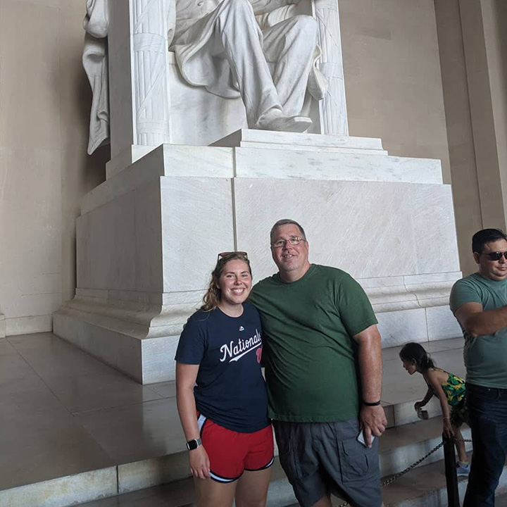 Rachel Kelley poses with her father in front of the Abraham Lincoln statue at the Lincoln Memorial.