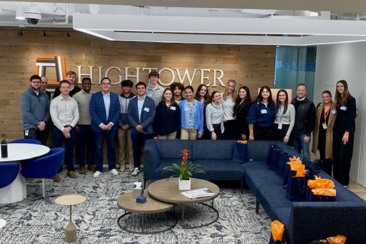 Bob Oros stands with CMU finance students during a visit to Hightower Advisors.