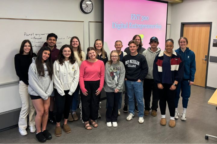 A group of 14 ENT 300 Digital Entrepreneurship students pose for a group photo in a CMU classroom in Grawn Hall.