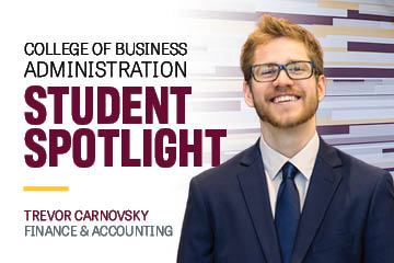 Image text: College of Business Administration Student Spotlight Trevor Carnovsky Finance & Accounting. Image: Trevor wears glasses, a dark blue suit jacket, white shirt and navy tie. He has light hair and a beard. He has a friendly smile.