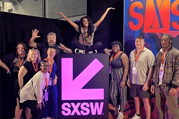 Stephen Wakeling and students posing and having fun by the SXSW sign.