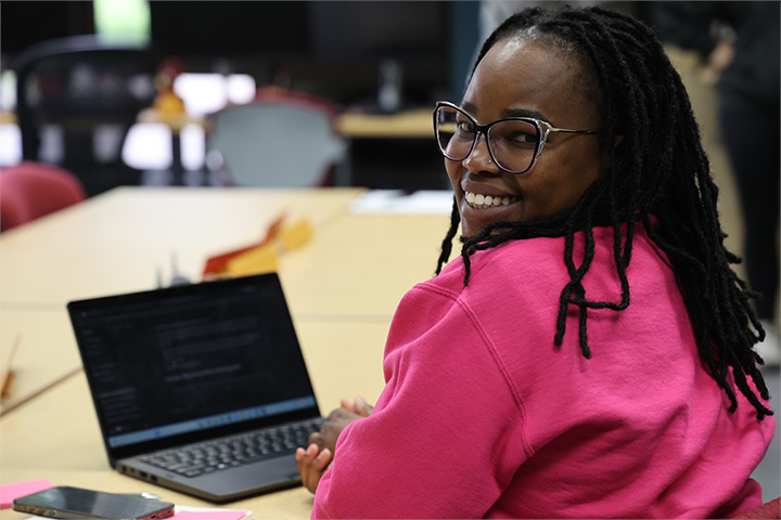 A student smiles in the idea den.
