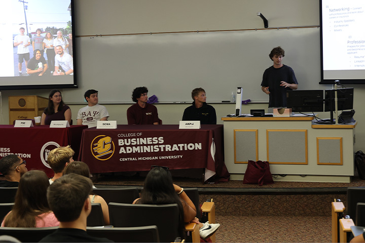 Business 100 students listen as various RSOs tell their story and try to recruit new members.