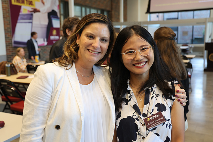 Drs. Shirley Huang and Christine Witt smile as they pose for a snapshot in the Grawn Atrium.