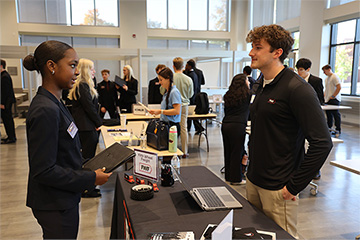 Sharply dressed BRC students are practicing their 30 second personal pitches as they prepare for the career fair. There are various recruiters stationed around the Atrium as students approach and give their elevator pitches hoping to land internships.