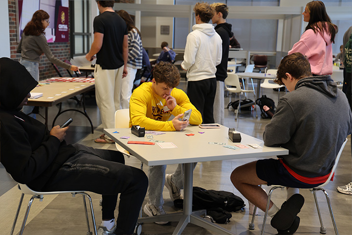 Students play a business process simulation