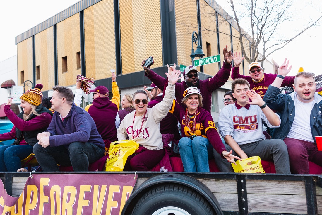 Central Michigan University Alumni ridding on a float during the Homecoming Parade