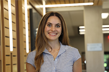 Lauren Bonomo stands smiling inside a Grawn Hall at Central Michigan University .