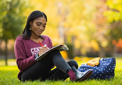 Central Michigan University Master of Business (MBA) Student sitting on loan doing homework
