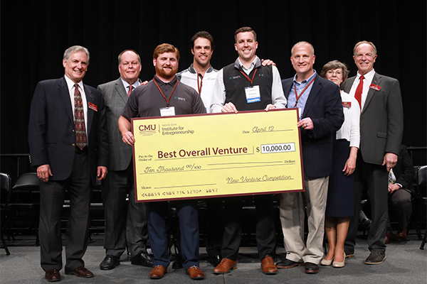 New Venture Competition team holding a large first prize check