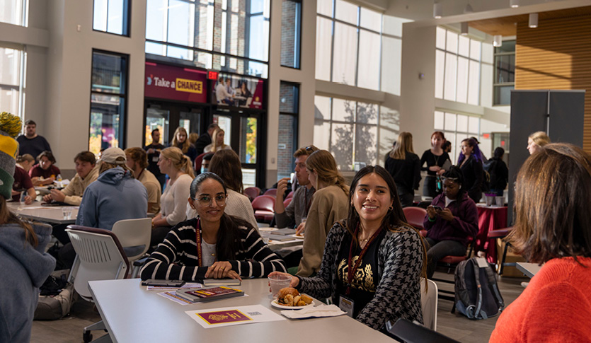 A group of students around a table during the NVC Kick-Off event in the Grawn Hall Atrium.