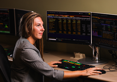 Female student working on a Bloomberg terminal in the Voigtman Financial Lab.