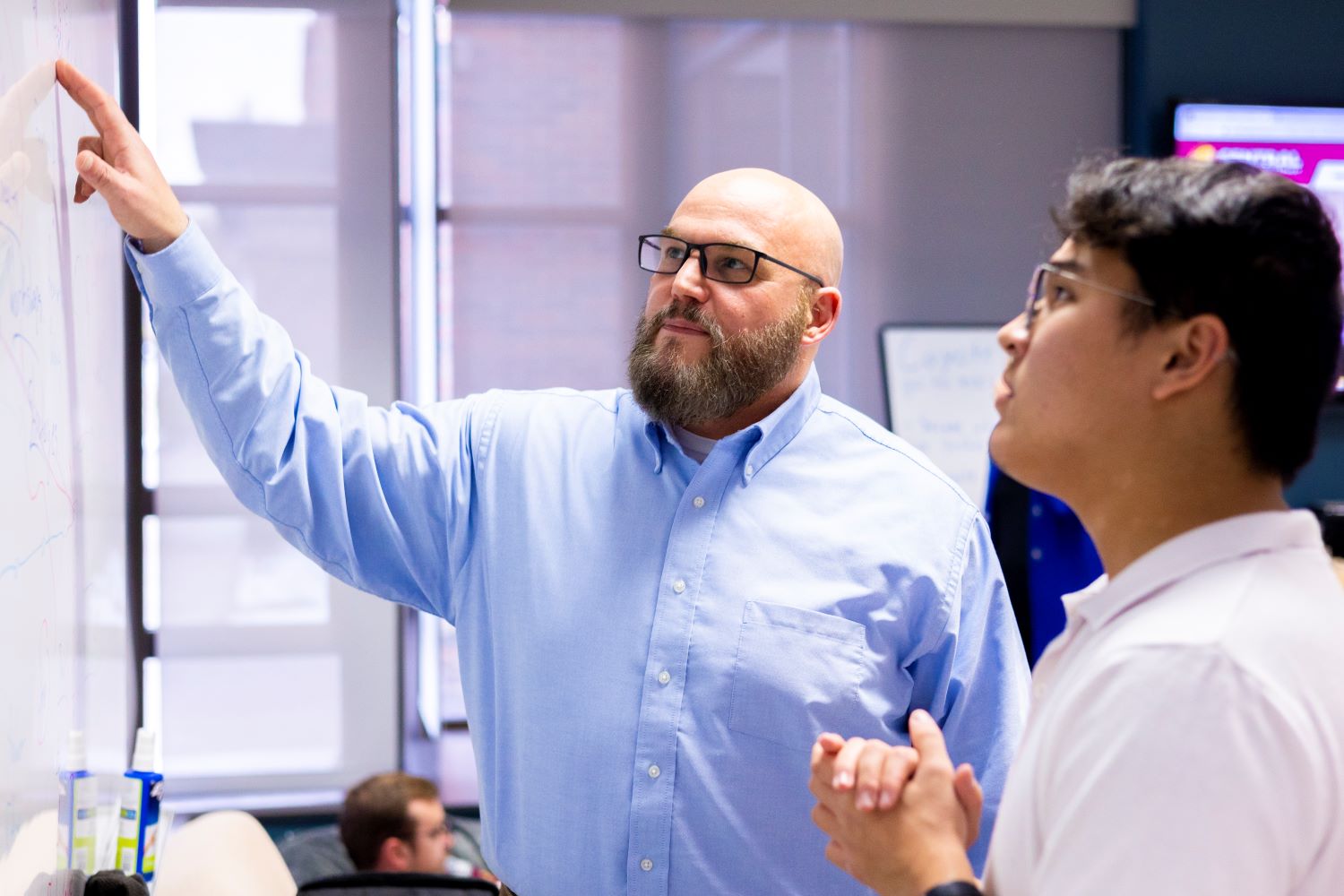 Professor John Gustincic teaching student Jake Kapusanky in the IDEA Den.