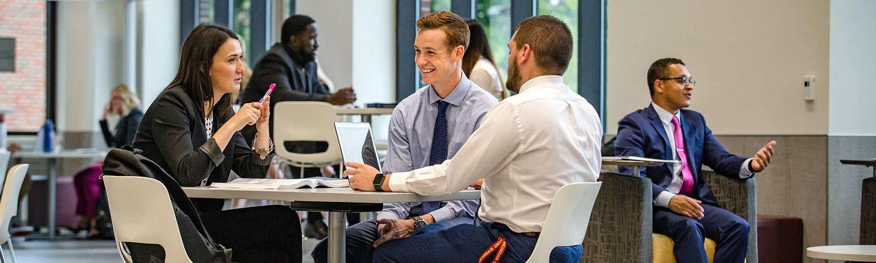 A group of people at a conference table talking