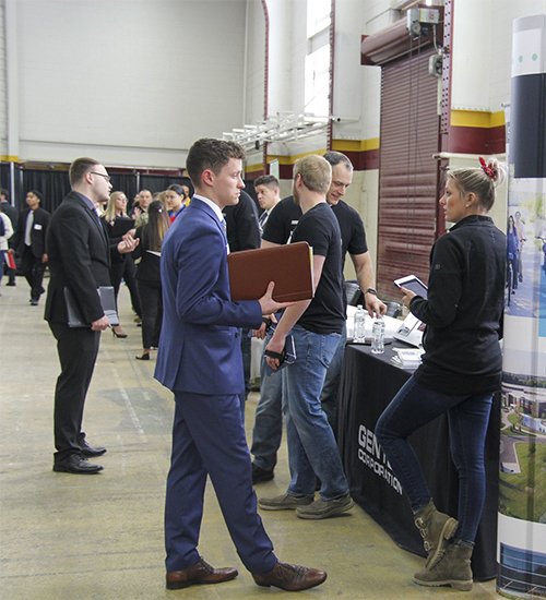 Alpha Kappa Psi Career Fair student interviewing with recruiter for an internship