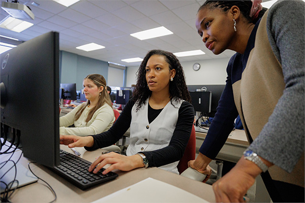 A group of women working in the SAP computer lab.