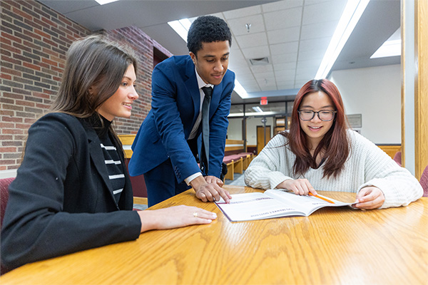 A group of students looking at a book