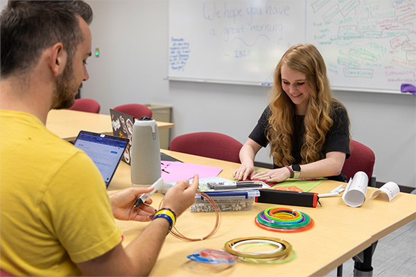 Two students working in the idea den