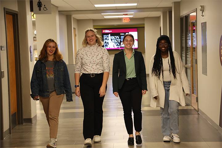 A group of women walking in Grawn Hall.
