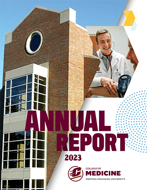 White background with an image of three level brick building with large windows on the left half and  a small chevron shaped picture of a male medical student taking a patients blood pressure and the words Annual Report 2023 on it.