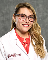 Isabella Rerstrepo, College of Medicine medical student wearing a white coat, smiling for a professional headshot.