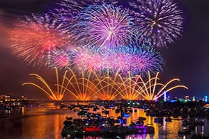 Pink and blue fireworks over a lake in Bay City, Michigan.