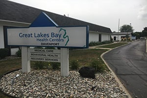A white sign for the Great Lakes Bay Health Centers Davenport location.