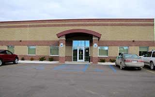 The research building in Mt. Pleasant, Michigan, a short, long and tan building.