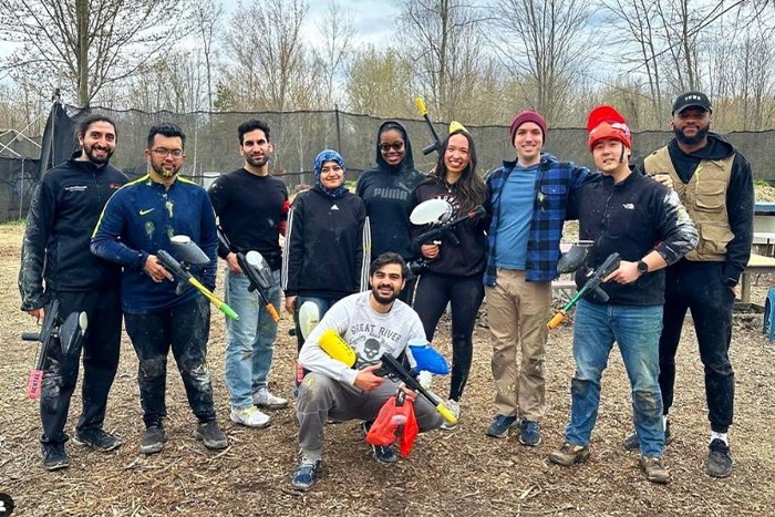 A group of residents pose for a photo prior to playing paintball.