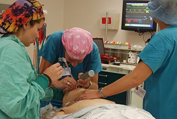 a group of medical professionals performing an injection