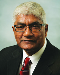 Professional headshot of Mohammad Jafferany wearing a blackblazer, white shirt and red tie.