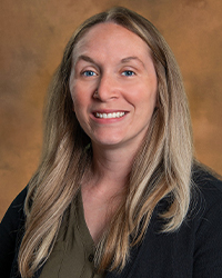 a woman with long blonde hair smiling