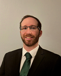 a man wearing glasses and a suit and tie.