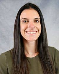 Headshot of Dakota Nerland wearing an olive colored blouse.