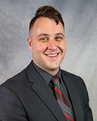Headshot of Matthew Kunz wearing a gray suit.