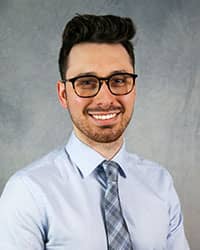 Headshot of Irfan Oymaqil wearing a dress shirt and tie.