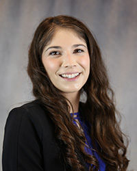 Headshot for Elizabeth Deming wearing a black blazer and blue top.